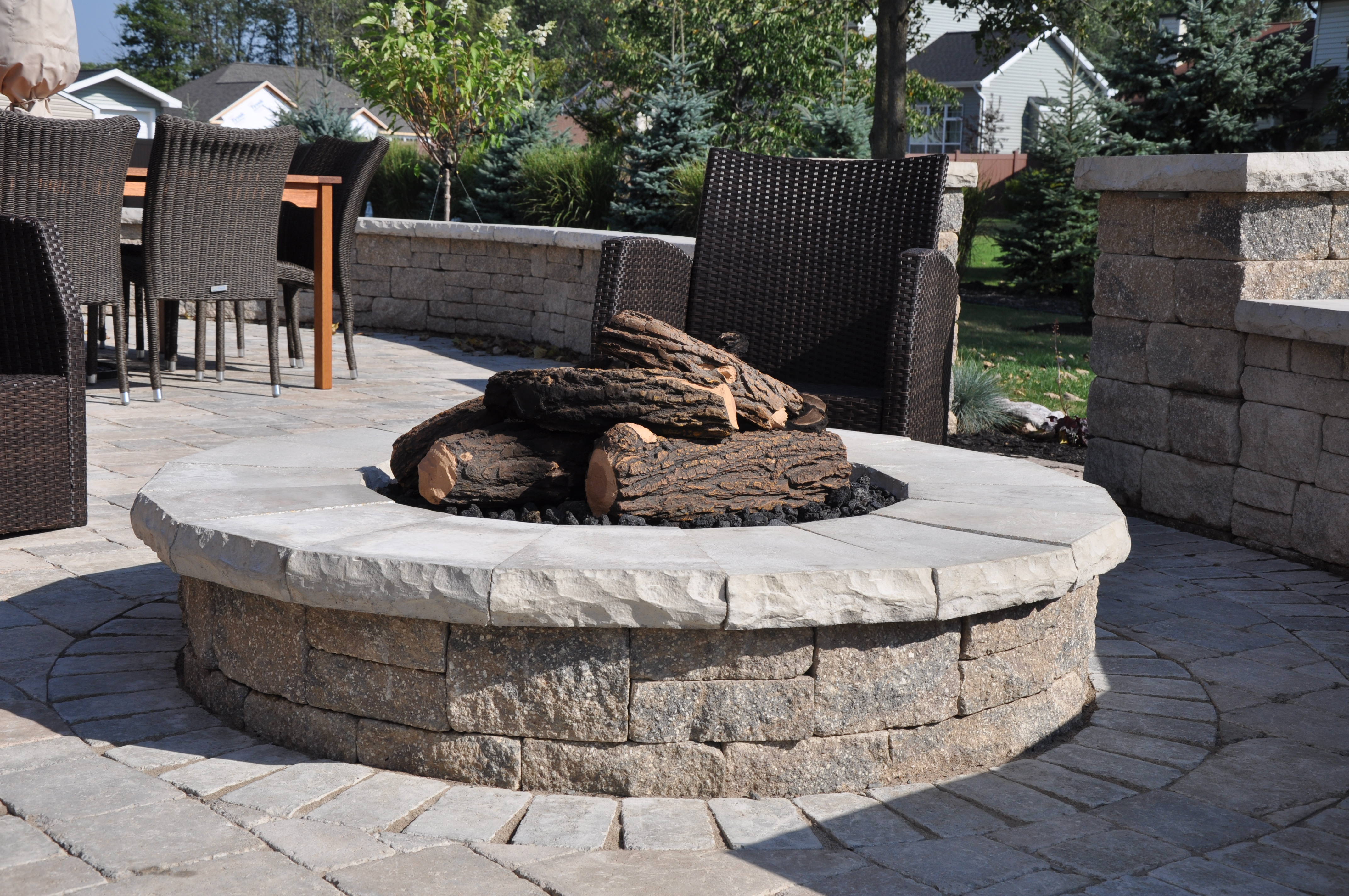 Patio, wall, grill island, natural gas fire pit, low voltage lighting, and planting